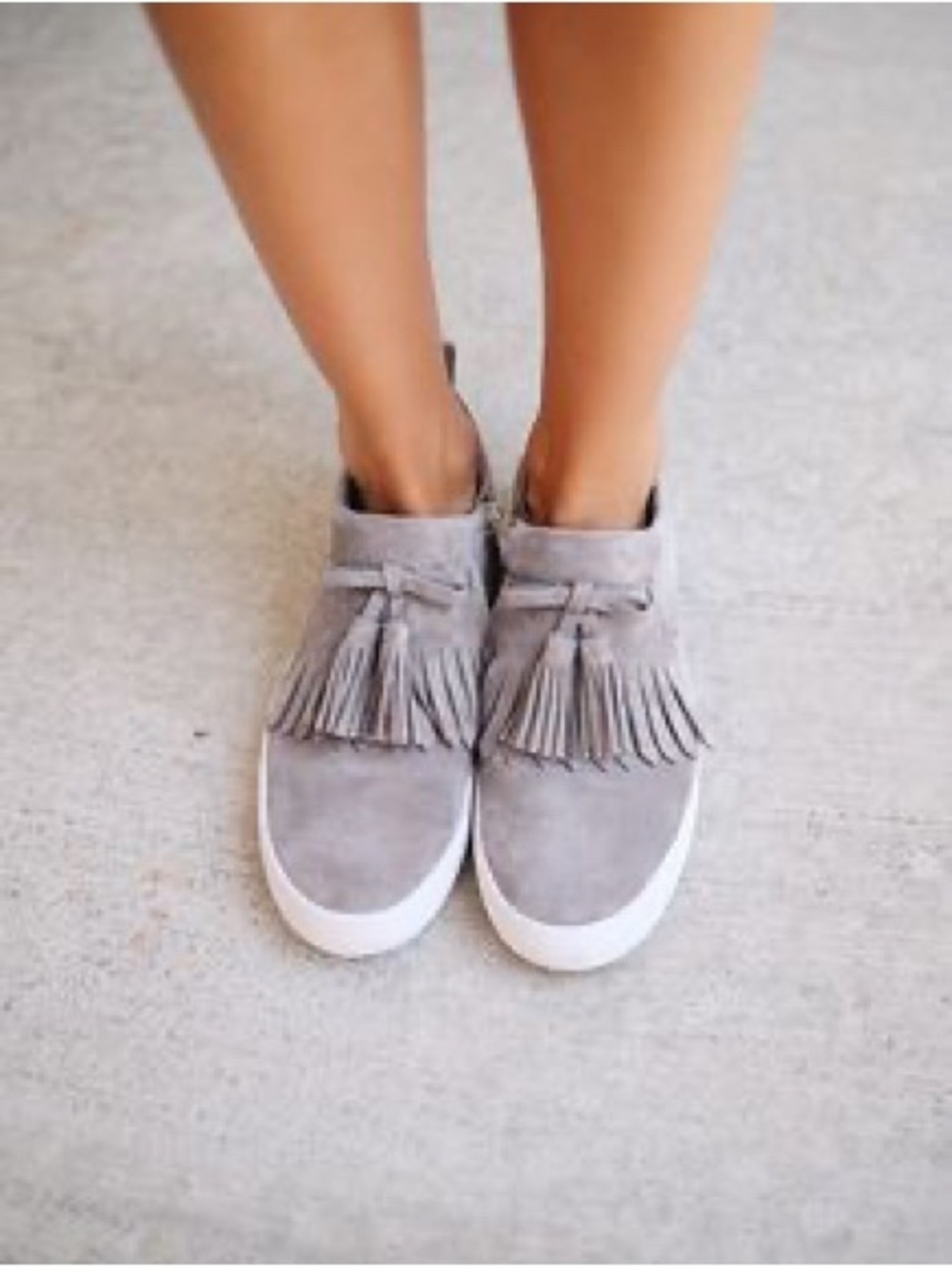 Kate Spade New York "Lenna" Tassel Sneakers in gray suede.